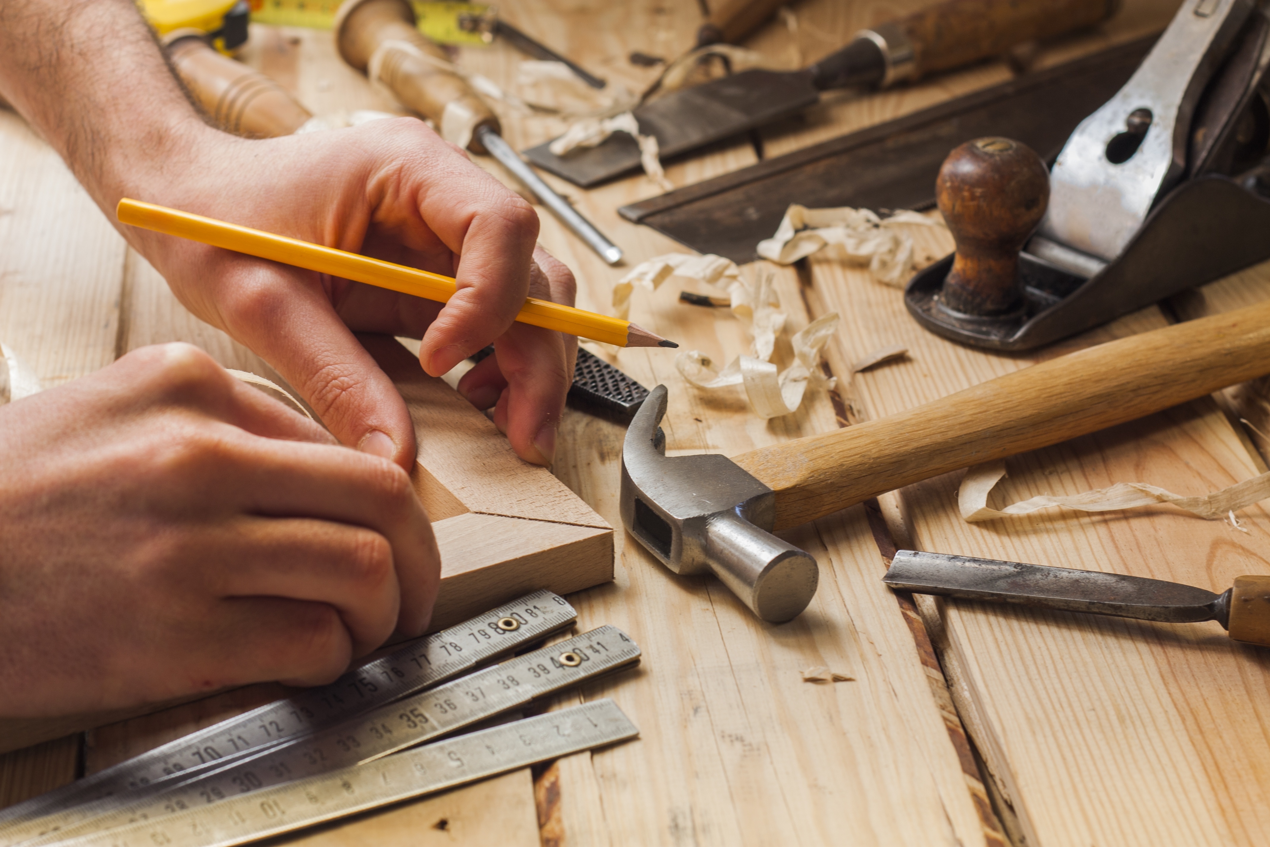 carpenter working,hammer and meter on construction background